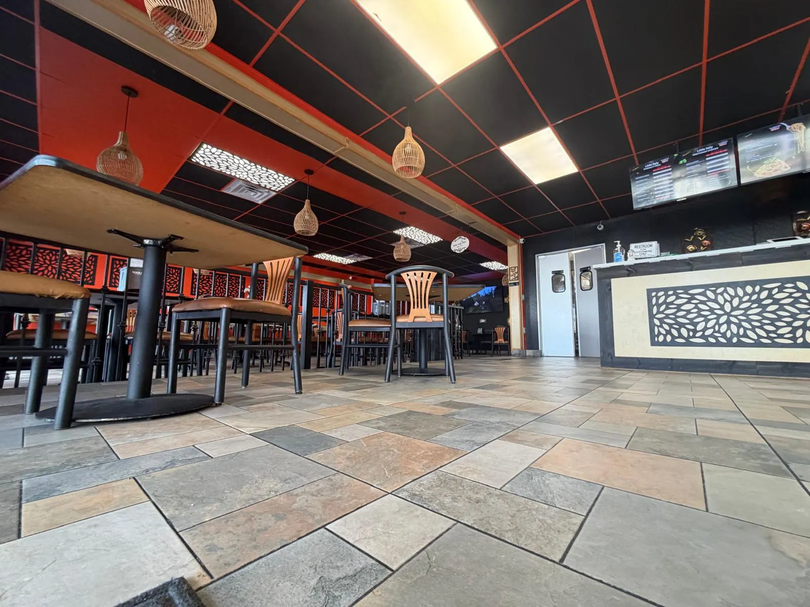 Inside Halal Table: red walls, wooden tables and pendant lights